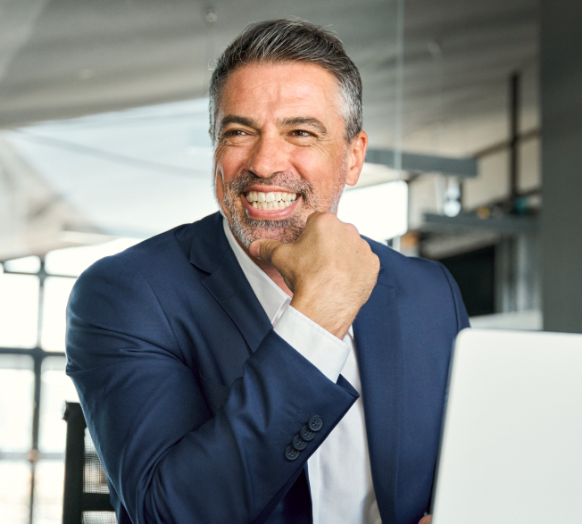 A smiling professional working at a laptop