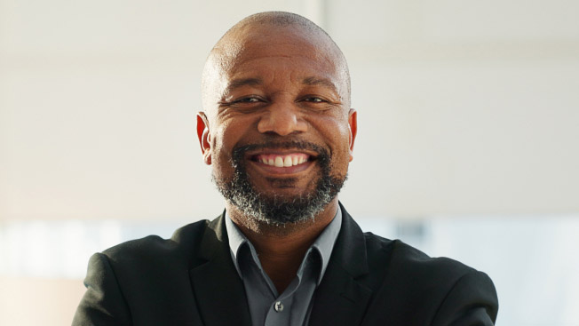 A photo of a man smiling broadly